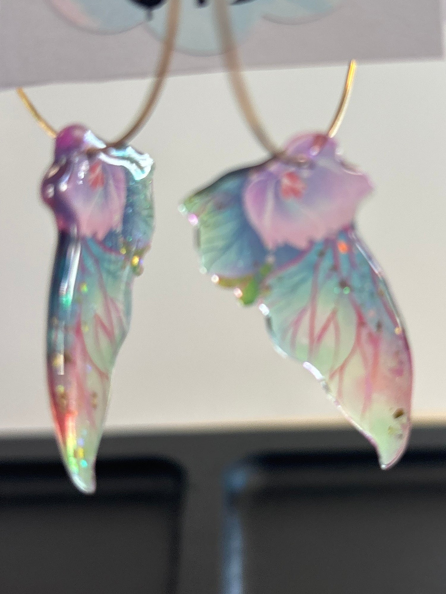 Colorful butterfly-shaped earrings on a card with 'Holly North Jewelry' branding.