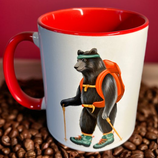 Mug with bear design on coffee beans against a red background