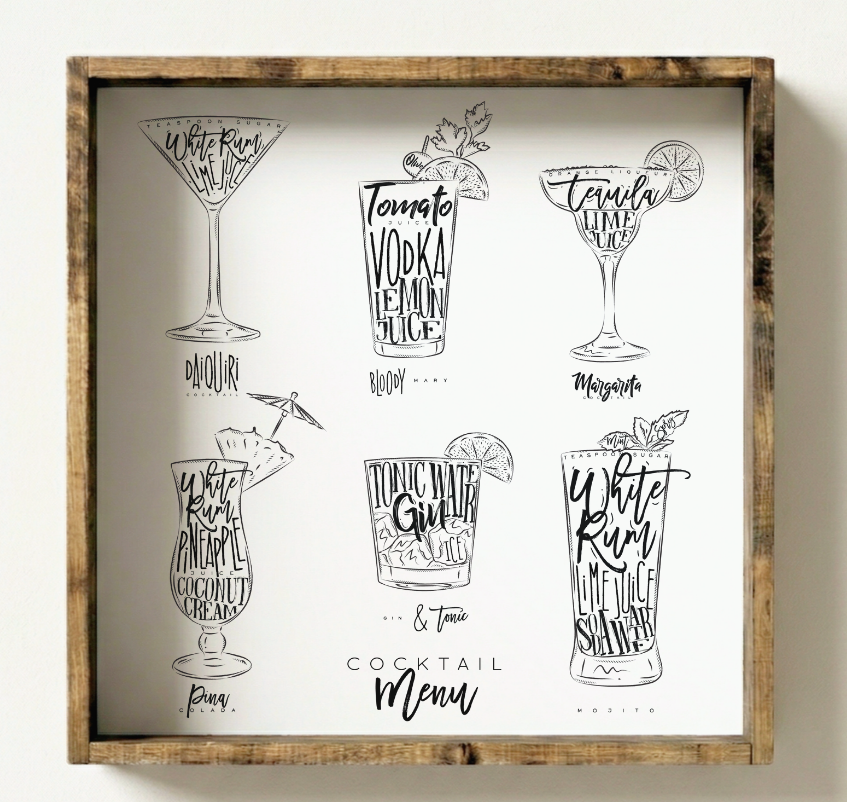 Framed cocktail menu with black and white illustrations on a white wall