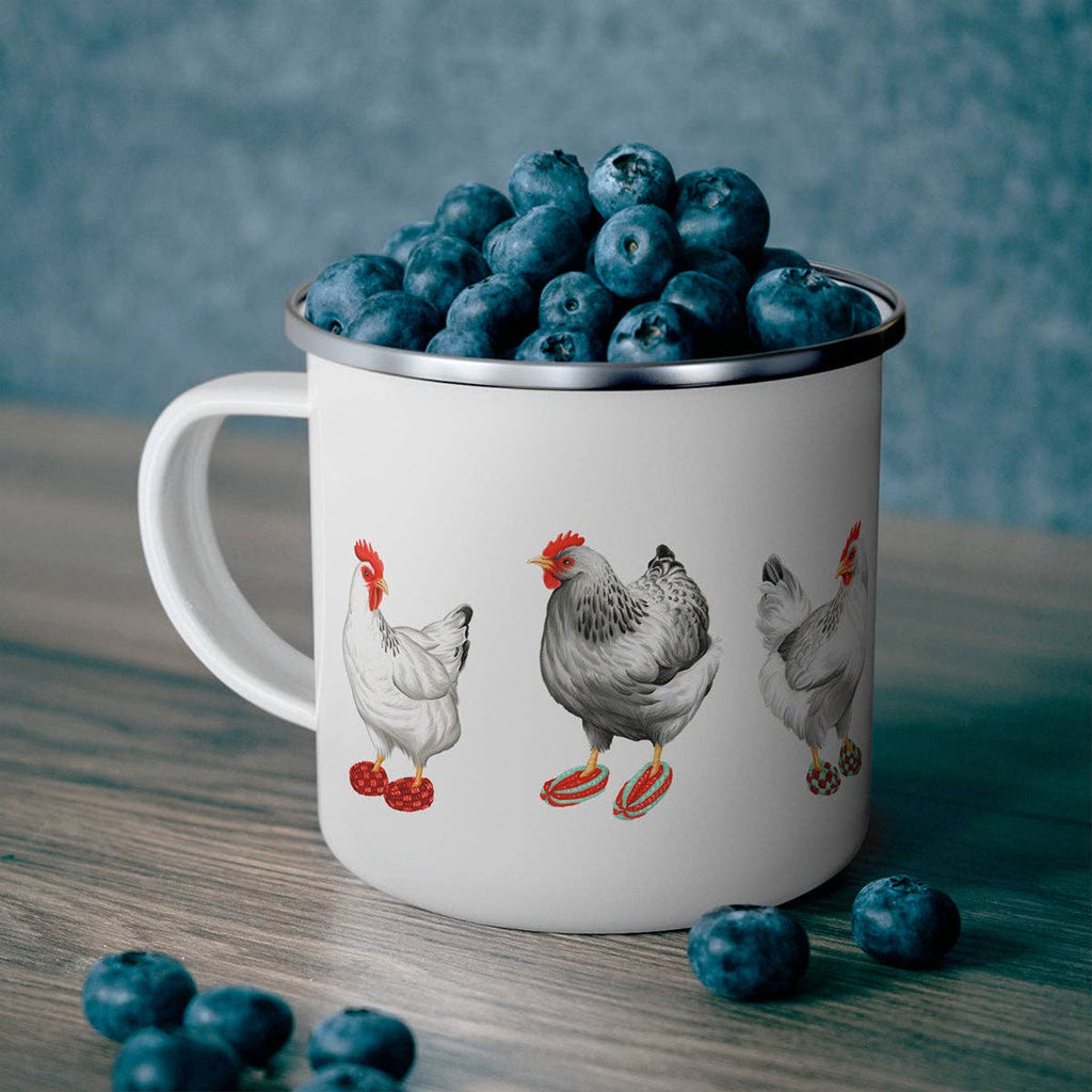 White mug with chicken illustrations filled with blueberries on a wooden surface.