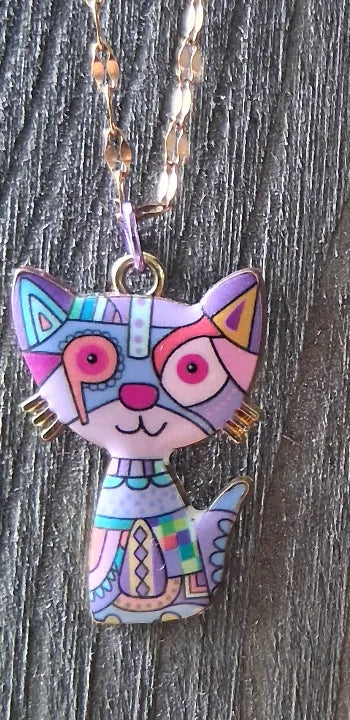 Colorful cat-shaped pendants on chains against a wooden background