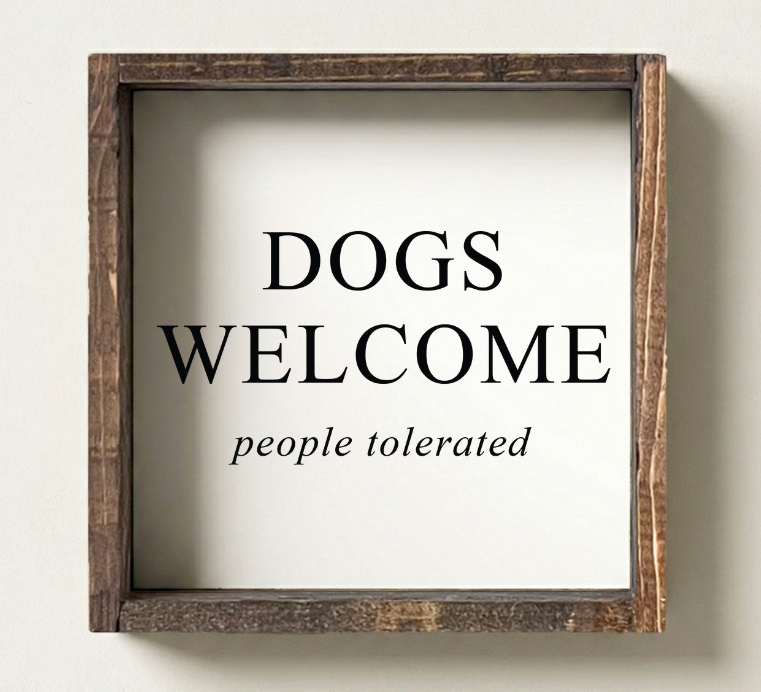 Wooden-framed sign with 'DOGS WELCOME people tolerated' text on a white background