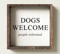 Wooden-framed sign with 'DOGS WELCOME people tolerated' text on a white background