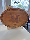Wooden coaster with engraved design on a white surface