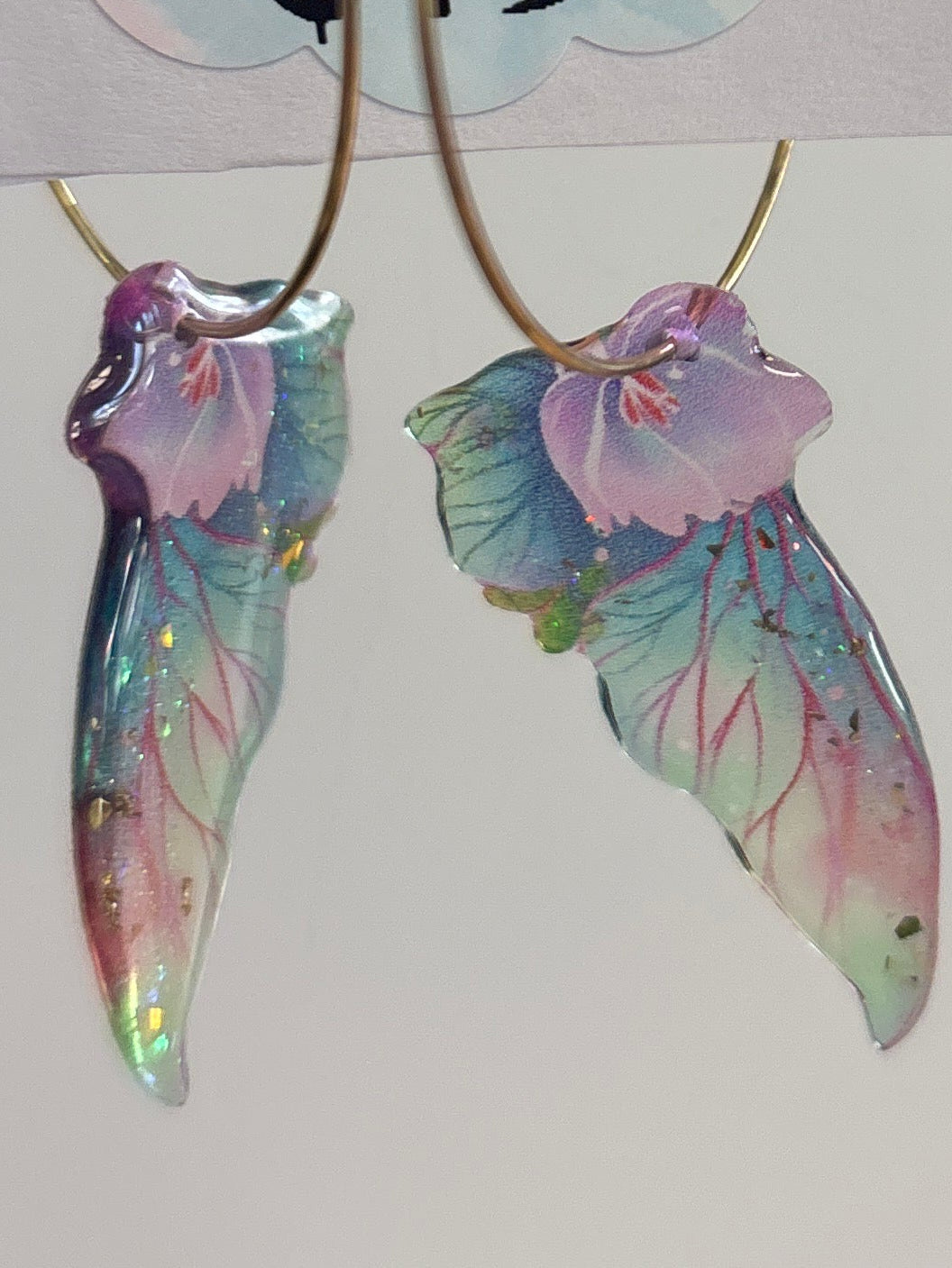 Butterfly-shaped earrings on display with a price tag.
