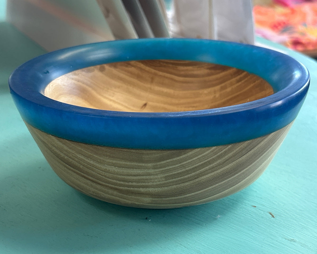 light wooden bowl with a blue resin rim