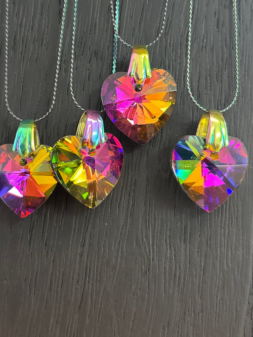 Colorful crystal pendants on a dark surface