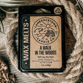 A single wax melt package labeled 'A WALK IN THE WOODS' by Lawrence Town Candle Co., placed on a rustic wood surface with burlap and rope props.