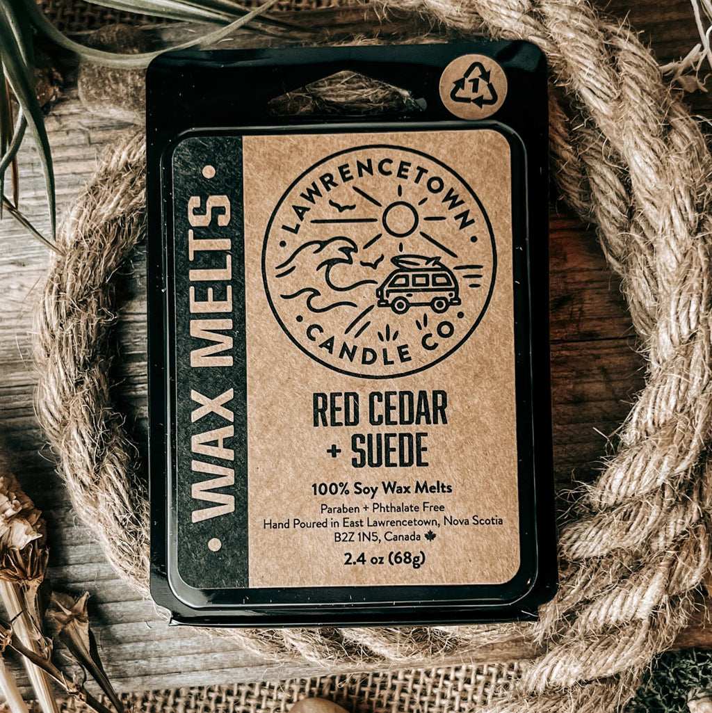 Wax melt packaging with branding on a rustic background