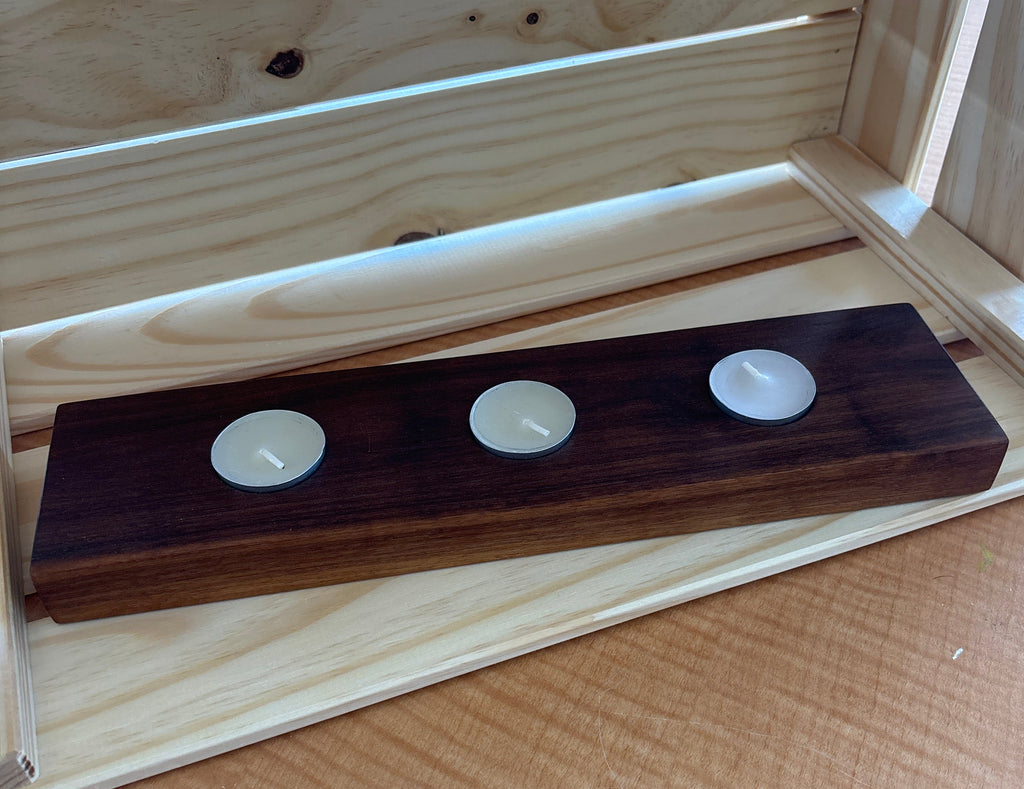 Wooden drawer slide with three white knobs on a wooden surface