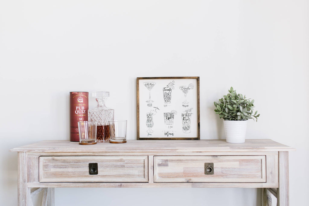 Wooden console table with decorative items against a white wall