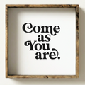 Wooden-framed sign with 'Come as You Are' text on a white background
