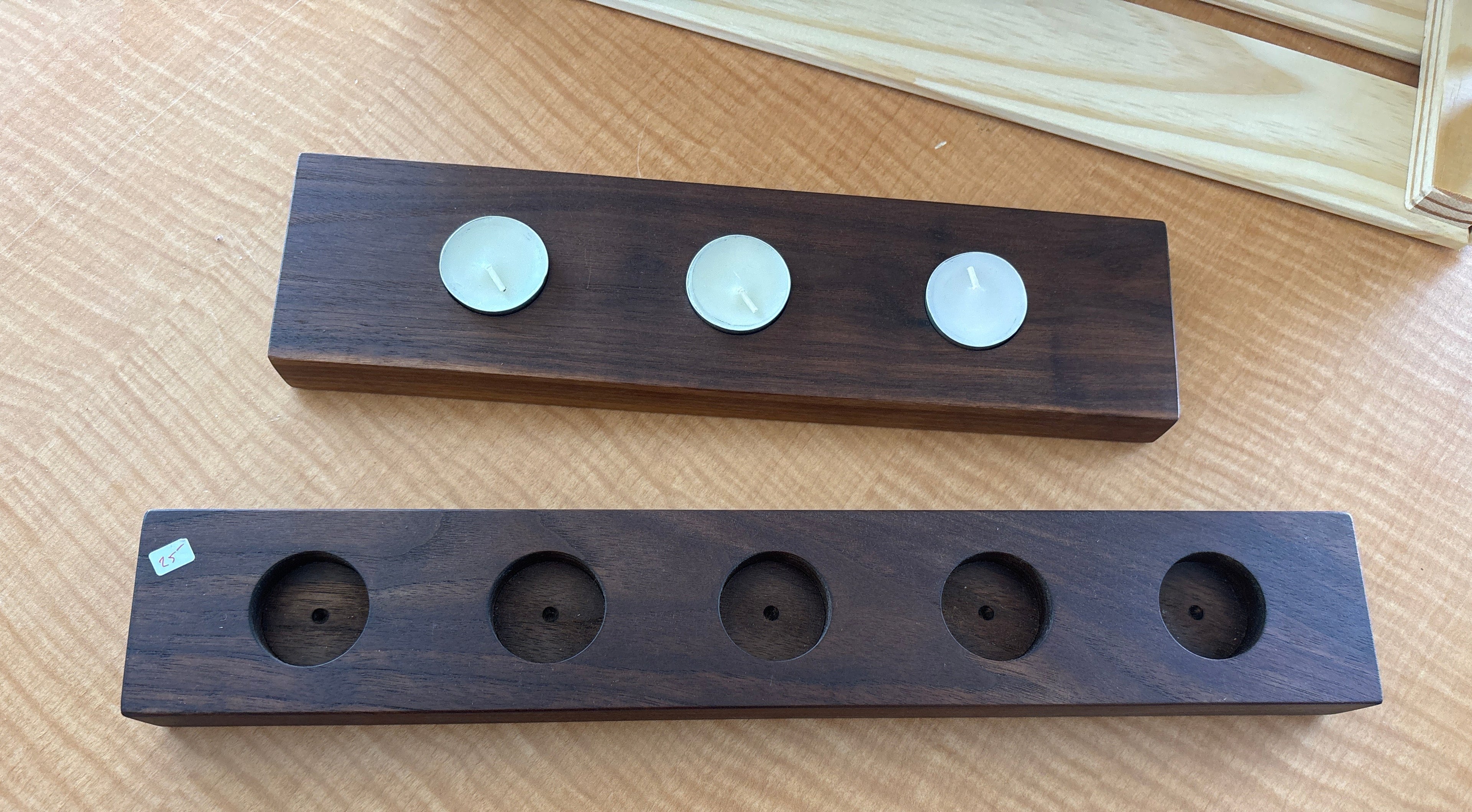 Two wooden blocks with circular holes on a wooden surface